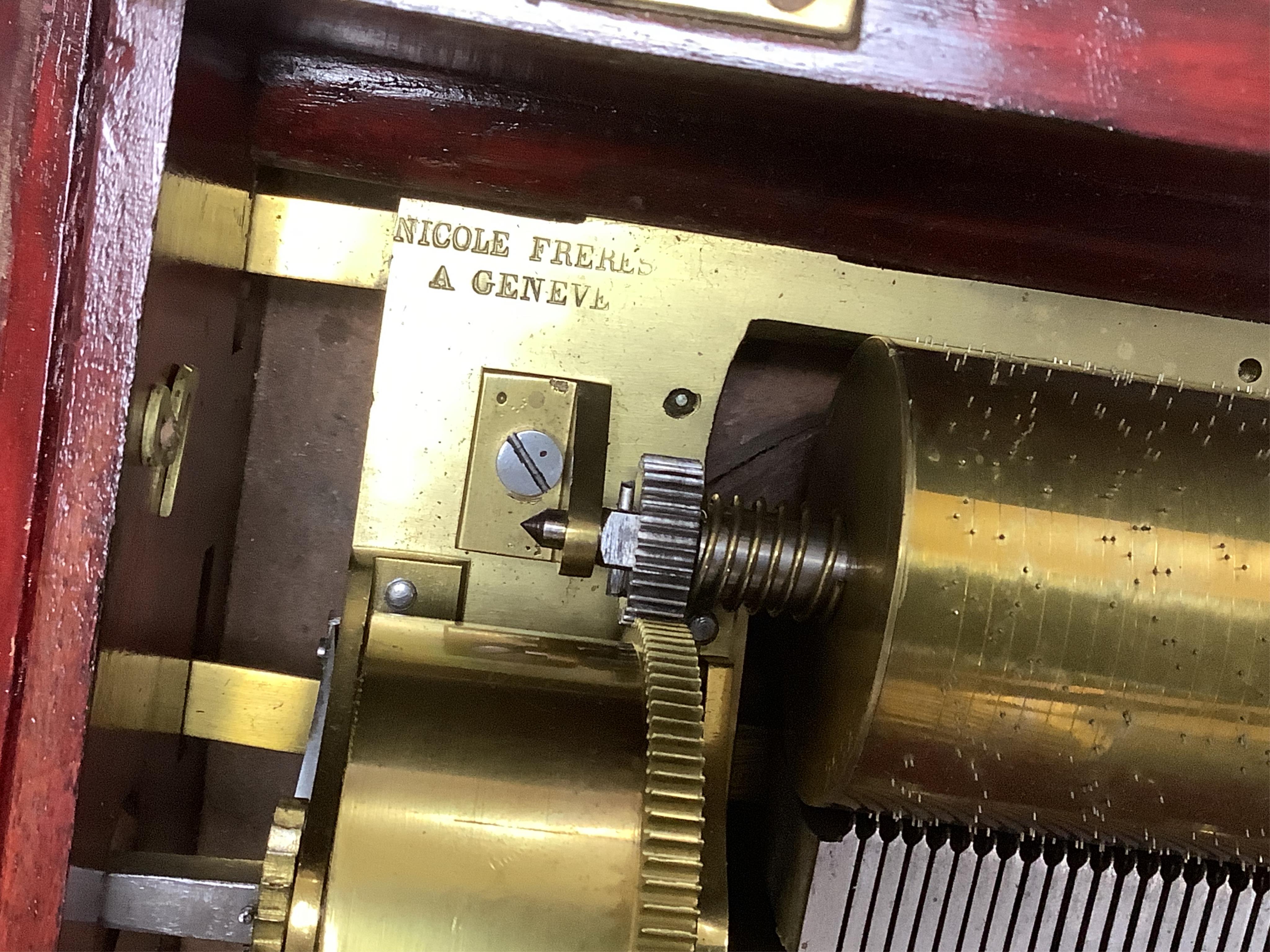 A mid 19th century Nicole Freres key wound cylinder musical box in an inlaid rosewood case, playing on approx 105 tooth comb, cylinder 27.5cm long, stamped ‘Nicole Frere a Geneve’, 26927, with key, the case; 45.5cm wide,